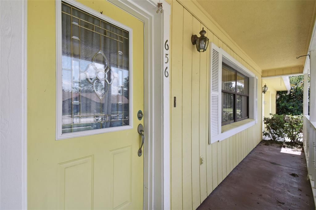 Beautiful leaded glass entry door and rocker ready front porch