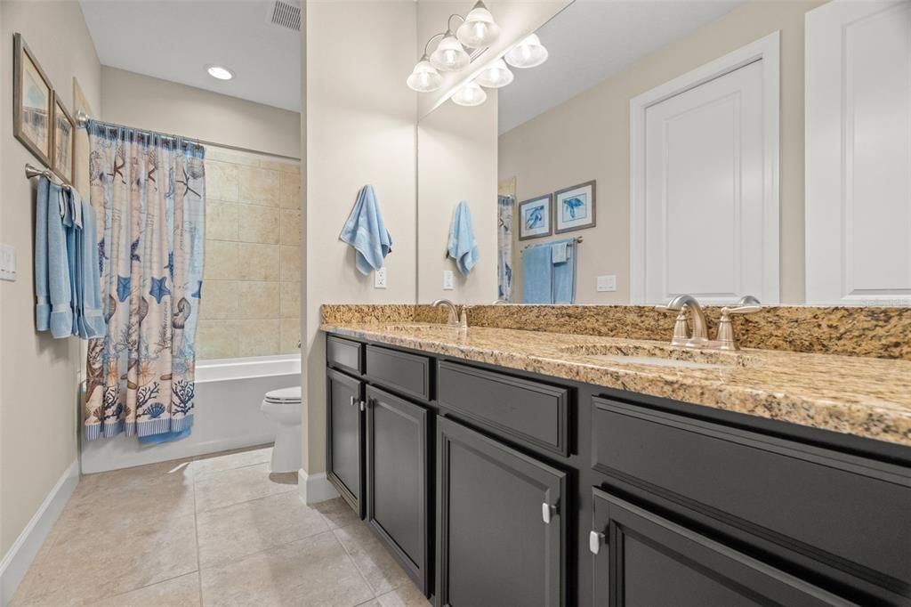 Bath 2 with dual sinks, granite countertops, raised height vanity