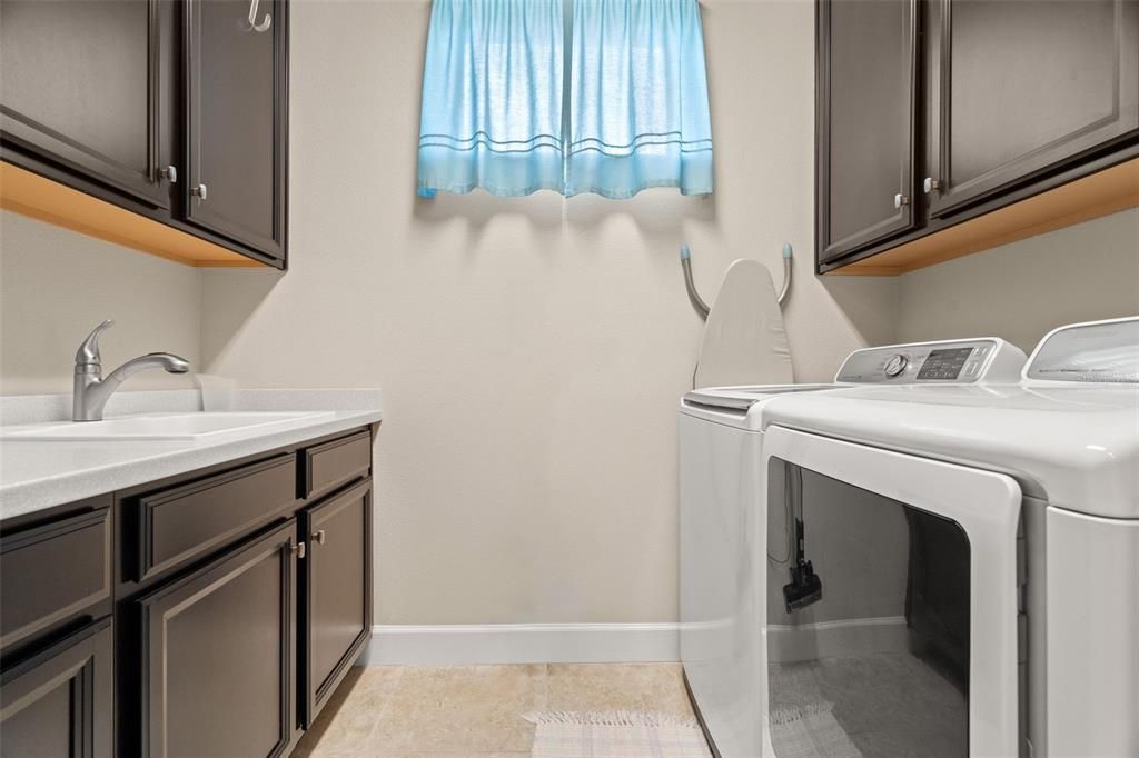 Laundry room with sink, cabinets & countertop