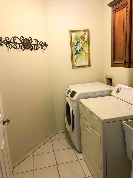 Laundry area with wooden cabinets