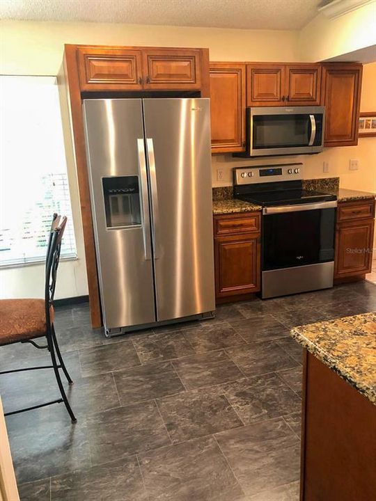 Kitchen with wooden cabinets and granite countertop