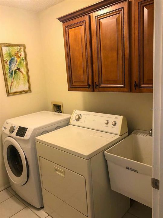 Laundry area with wooden cabinets