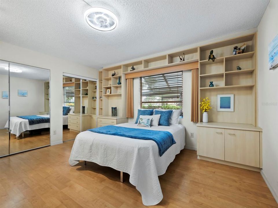 The built-in shelving, dual closets offer an abundance of storage. Hidden behind mirrored doors of the left closet, is more built in shelving and a Murphy-style desk.