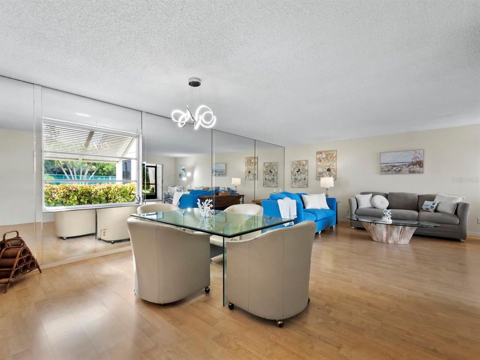 The open concept floorplan with dining and great room is filled with an abundance of natural light.