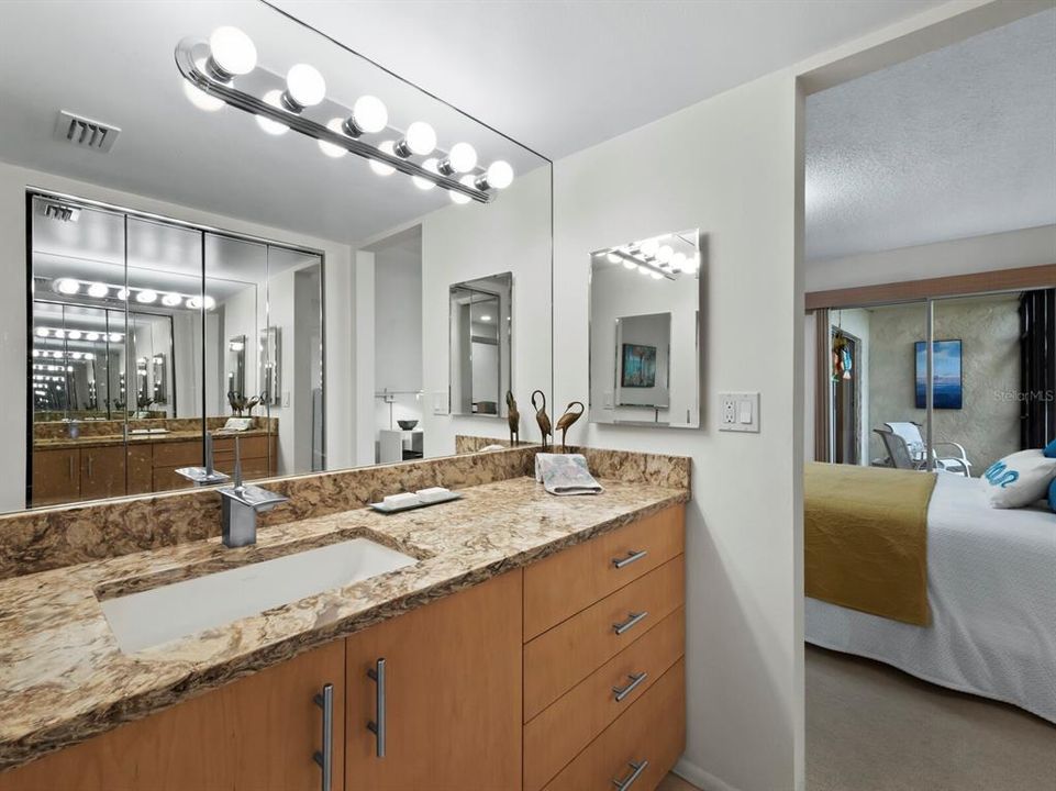 Getting ready in this bathroom is a delight with bright lighting and mirrored closet doors capturing your entire ensemble.