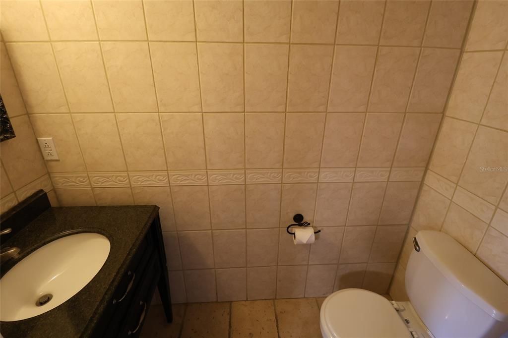 Half bath has tiled walls