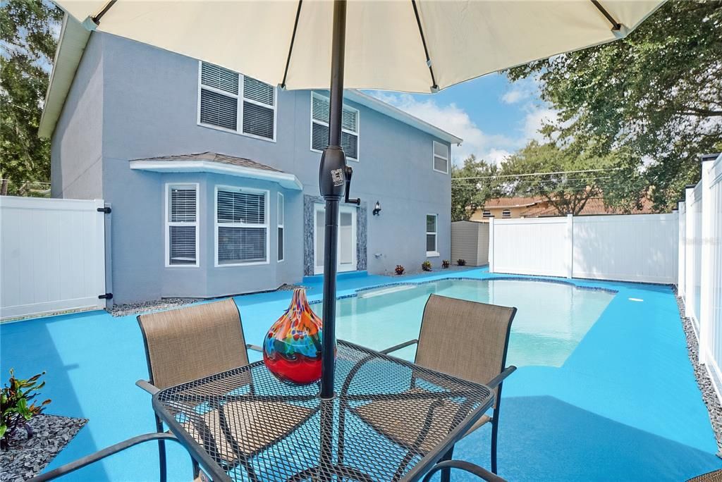 The primary bedroom ensuite on second floor overlooks the pool and Deerview Lake.