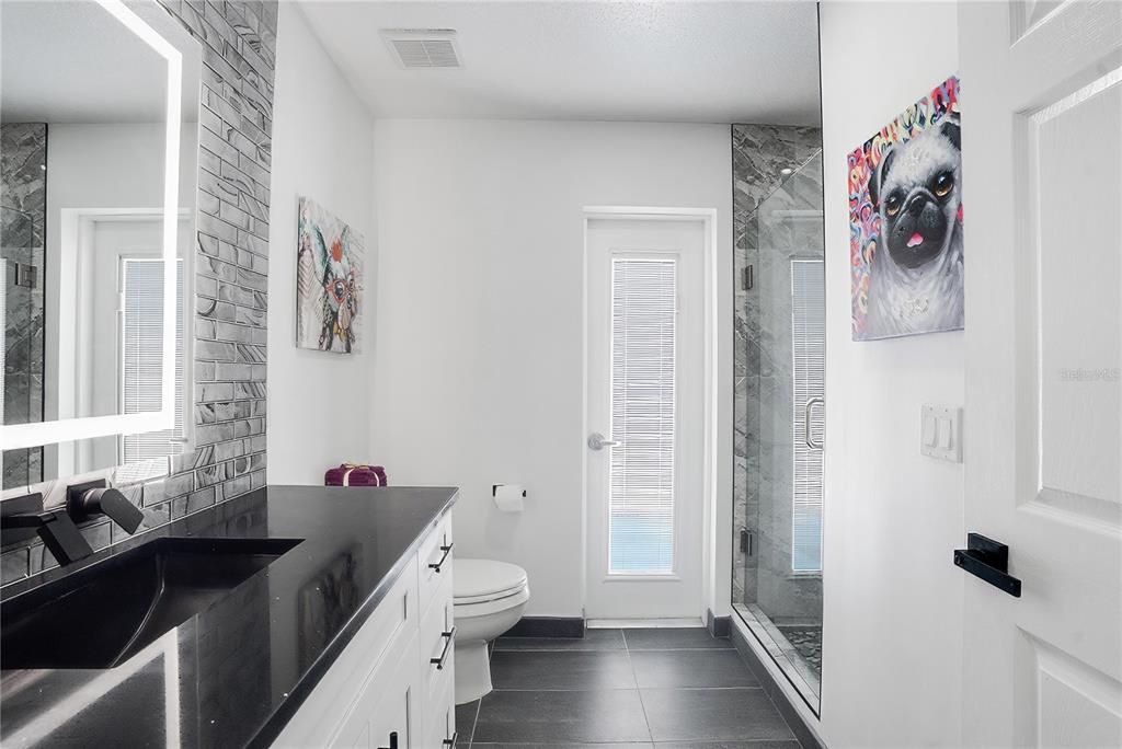 The faucet on the wall can be titled up so after brushing your teeth you can rinse your mouth with water.  The bathroom door that leads to the pool has blinds built in.