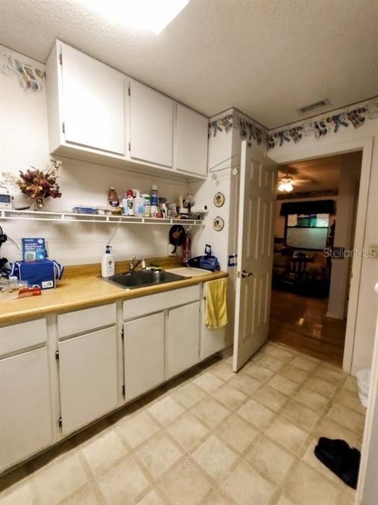 Laundry room offers a lot of built in storage and a desk