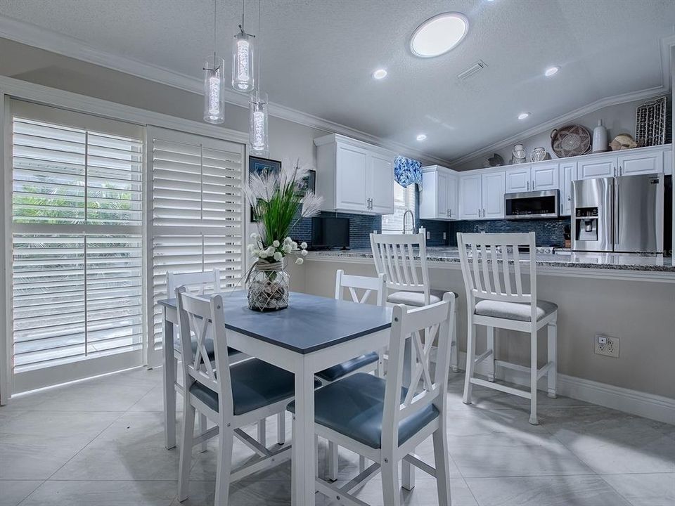 SOLAR TUBE FOR NATURAL LIGHTING. DINING ROOM WITH NEW CUSTOM LIGHT FIXTURE.