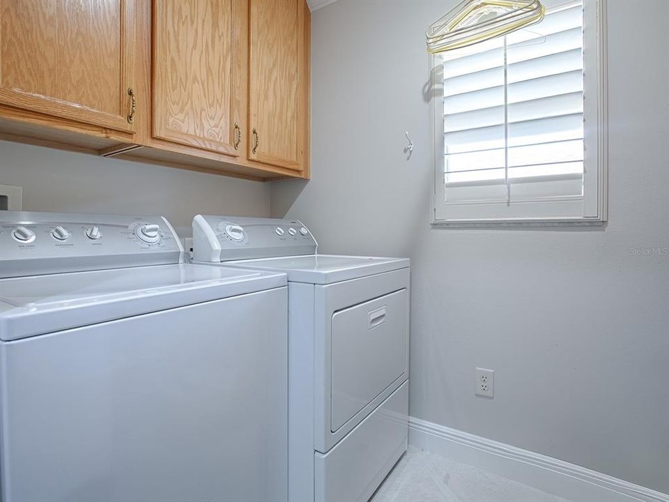 LAUNDRY ROOM WITH EXTRA CABINETS. WASHER AND DRYER DO CONVEY WITH THE HOME.