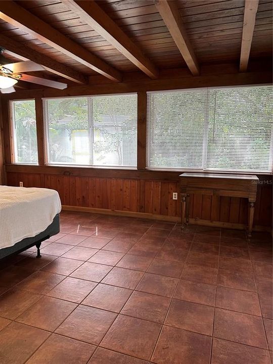 large windows with new blinds overlooking back yard from primary bedroom