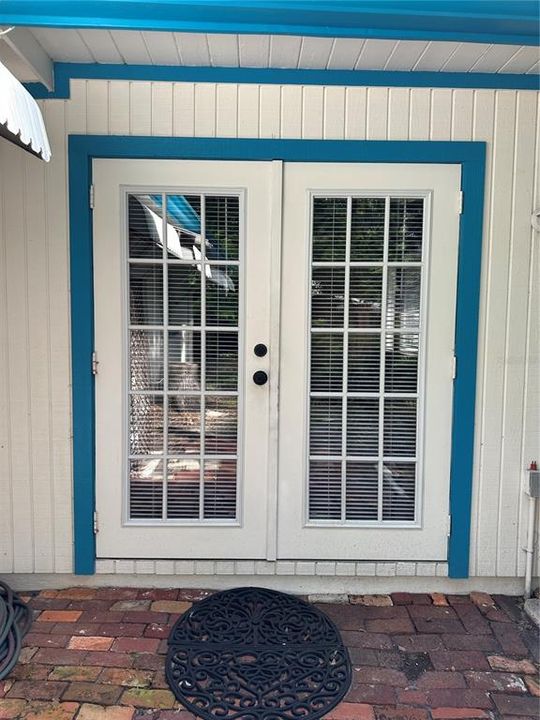 French doors leading from back yard to primary bedroom