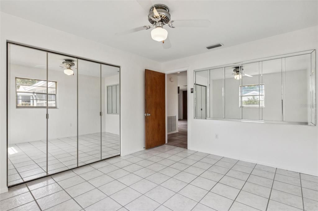 Bedroom with mirror doors