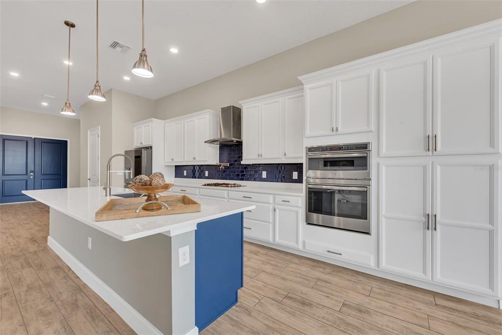 Notice the Cooktop with range hood and wall oven and microwave with lots of storage and the breakfast bar on the island.