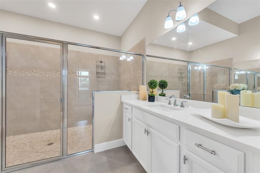 Primary ensuite bath with dual sinks and quartz counters and large walk in shower.