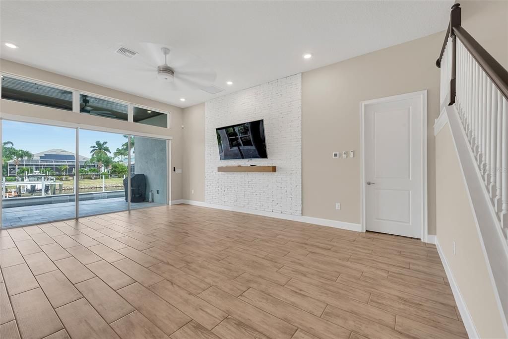 The great room has sliders out to the lanai and pool.