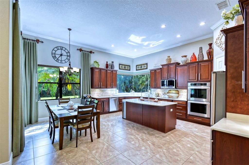 The AWESOME kitchen is a CHEF'S delight: The option of a GOURMET kitchen brings double ovens, smooth cook-top, QUARTZ counters, enhanced with TILED BACKSPLASH with INLAY, UNDER-MOUNT SINK, pot drawers, and soft close drawers.