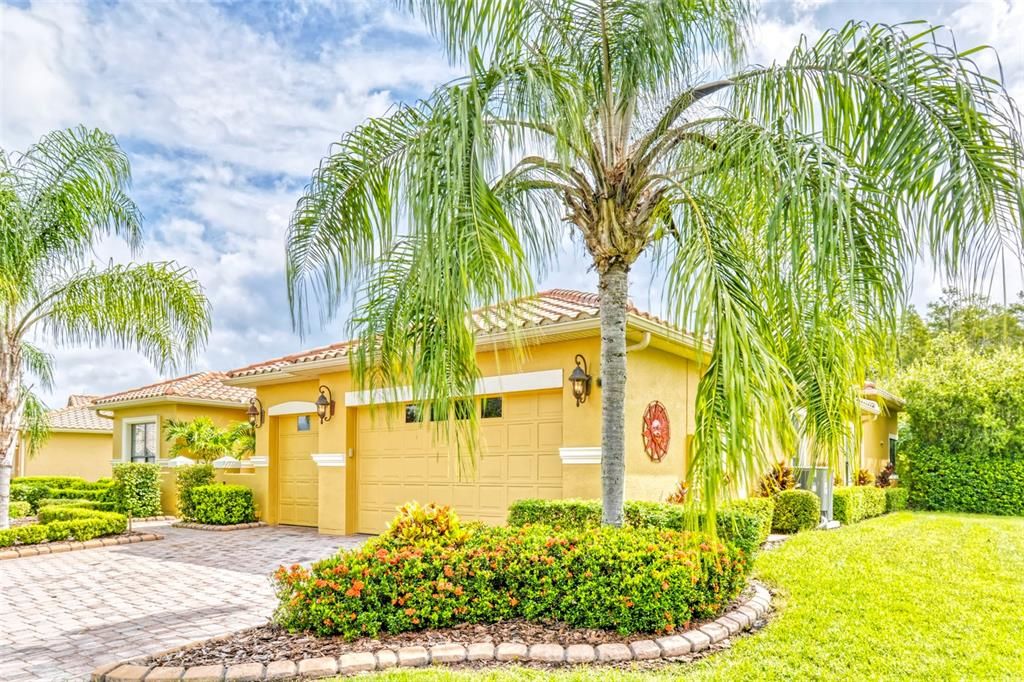 This home is nestled among beautiful palms and shrubs