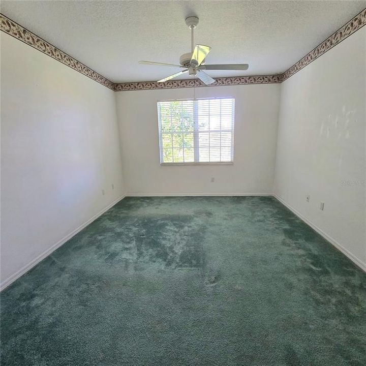 Master bedroom with golf course view from window.