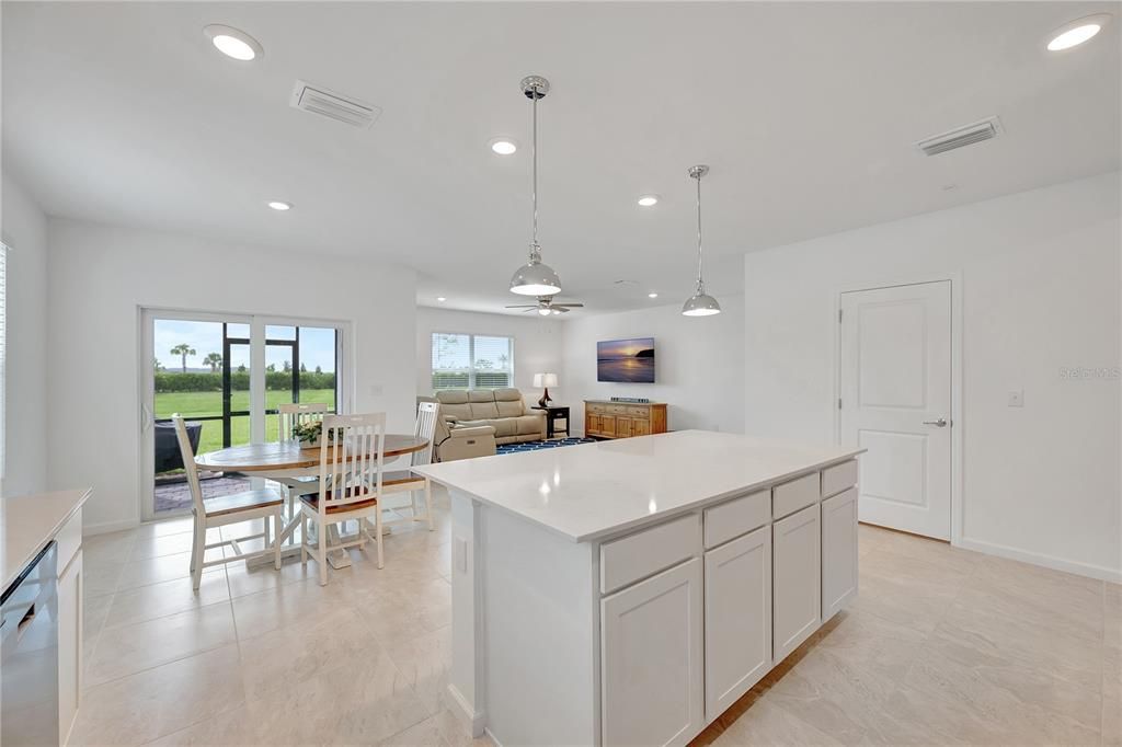 Kitchen view to backyard, sliding doors open to the lanai.