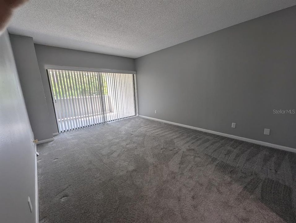 Primary bedroom with en suite and door to covered patio