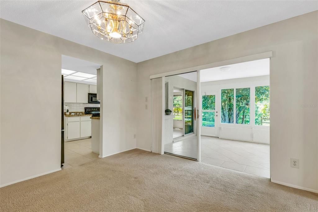 Dining room with access to the updated kitchen, the bonus sunroom through large sliders, & the master suite to the right~