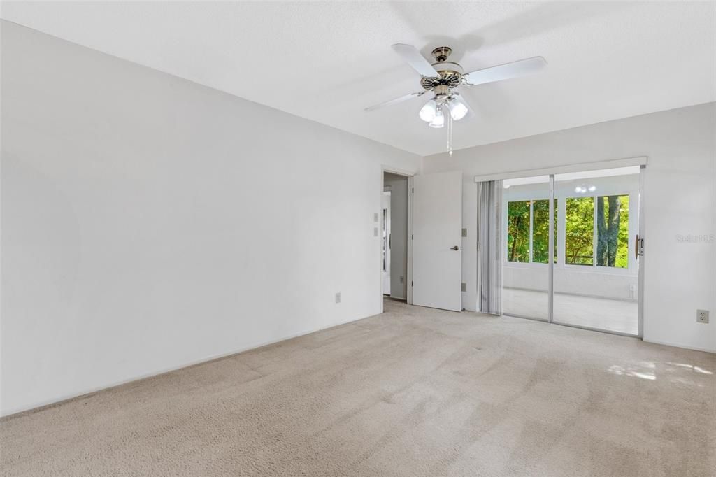 Large sliders lead to the relaxing sunroom directly from the master suite~