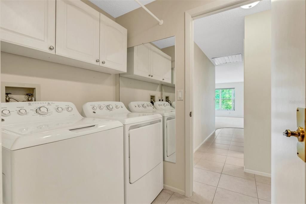 Laundry room with utility sink & extra cabinets nicely located between hall & garage~