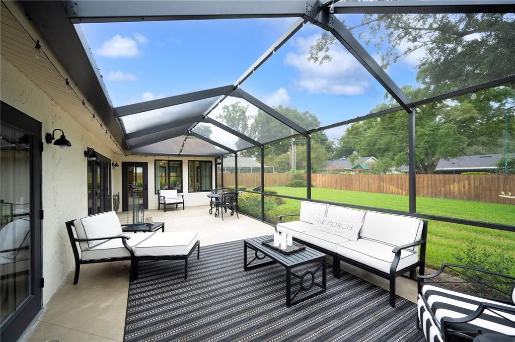 Screened in patio off the kitchen and primary bedroom