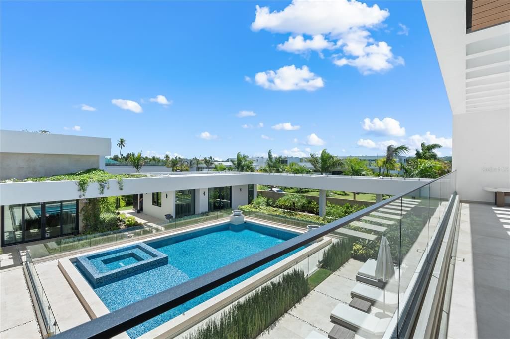 Courtyard Pool surrounded by mature tropical landscaping.