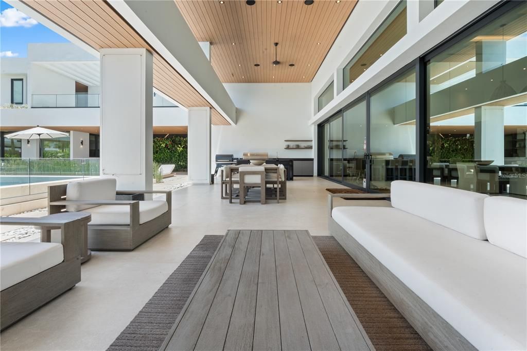 Composite teak on the exterior ceiling for this outdoor dining table, sitting area and exterior kitchen.