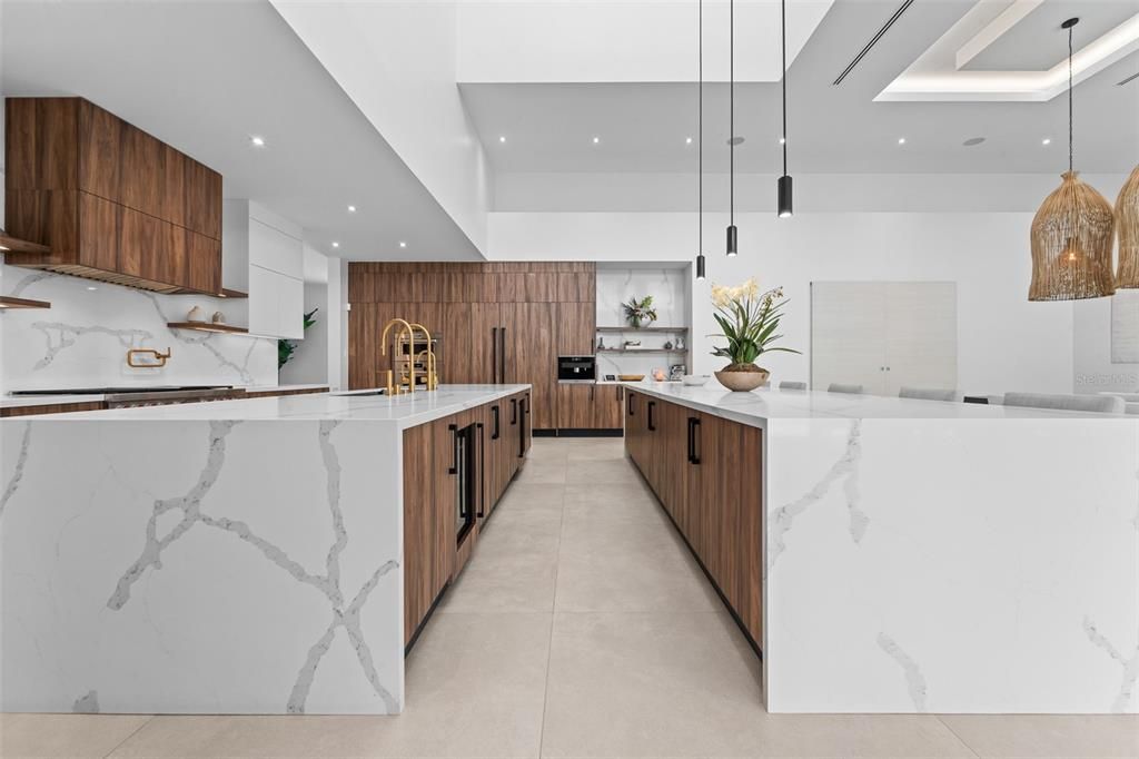 This kitchen has paneled appliances with subzero refrigerator and freezer, wolf gas Range, dual dishwashers.