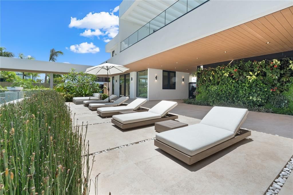 Courtyard pool features living wall, two fire bowls, waterfall, and underwater lights. This jacuzzi and pool can both be heated.