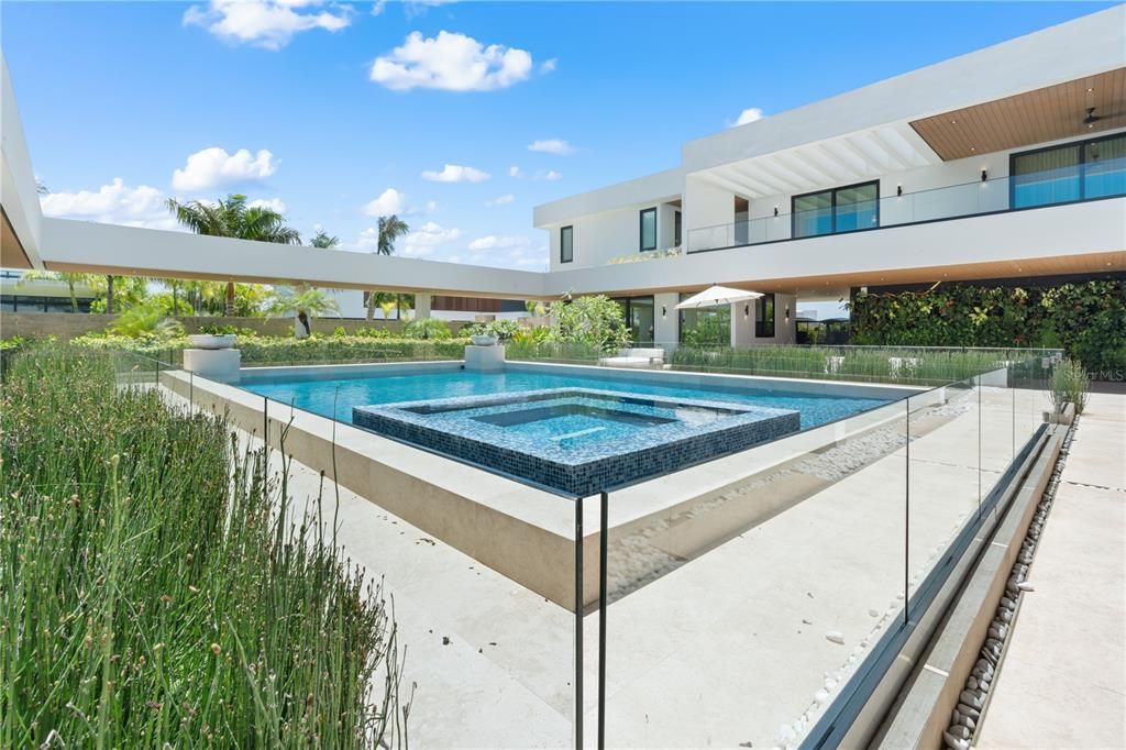 Glass surrounds the 40K gallon pool and serves as a functioning yet chic baby gate for child safety.