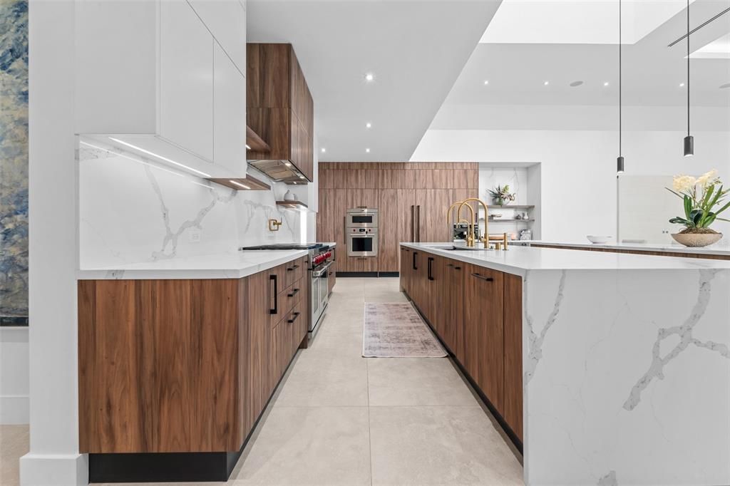 This kitchen has two 14 foot islands with paneled appliances: subzero refrigerator and freezer, wolf gas Range, dual dishwashers. Two subzero beverage fridges and miele coffee maker by the coffee bar.