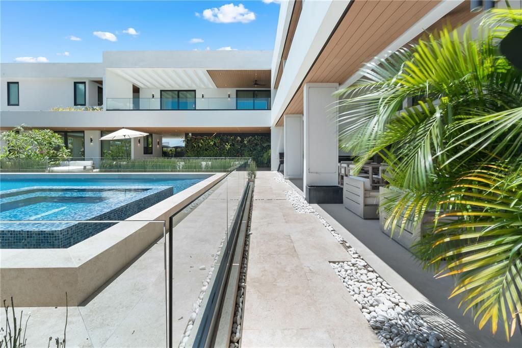 Glass surrounds the 40K gallon pool and serves as a functioning yet chic baby gate for child safety.