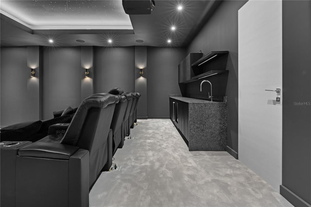 Home Theatre under the stars featuring wet bar, bathroom, bucket cinema seats and sofa seating.