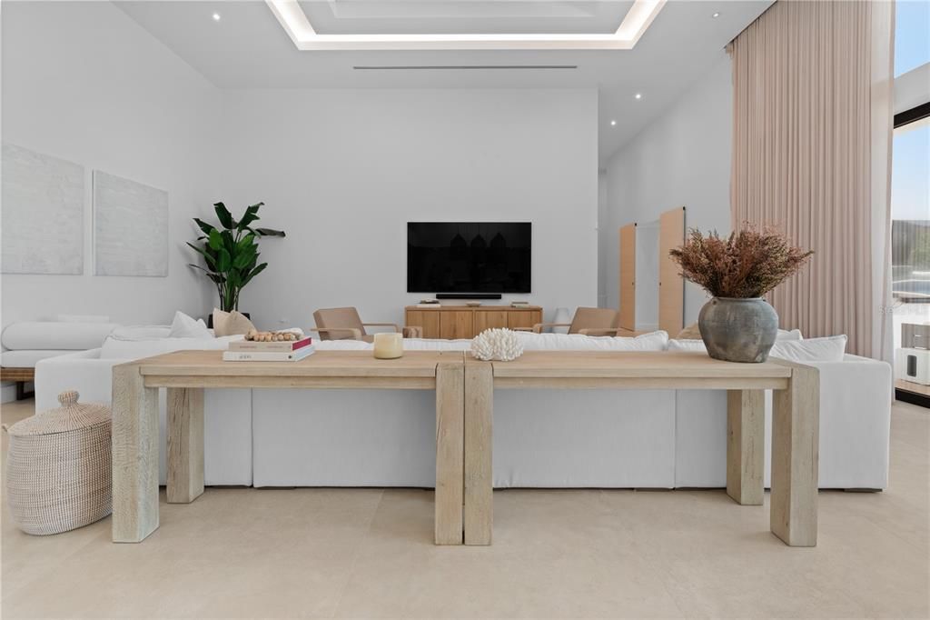 Natural light beaming from above kitchen island window with pendant lighting and led lights throughout the kitchen for night time lights. Custom kitchen cabinets are imported from Italian brand Cucina Lube.