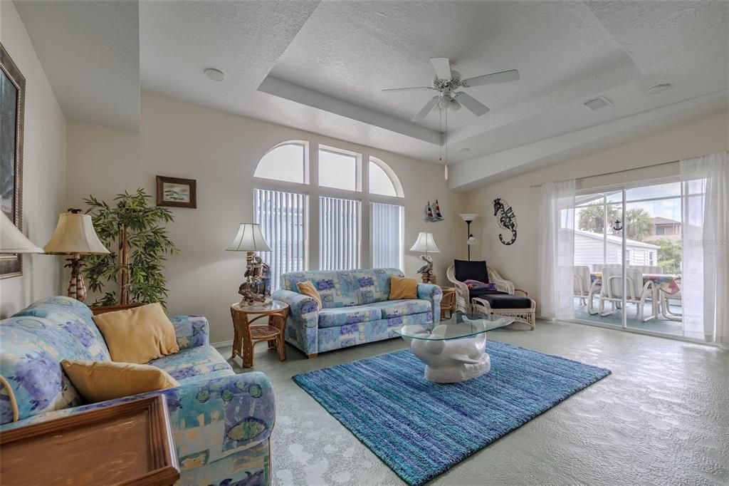 Windows and Sliders to fill the room and high ceilings with natural light