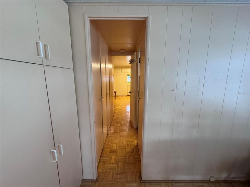 hallway leads to the Hall bath and guest room