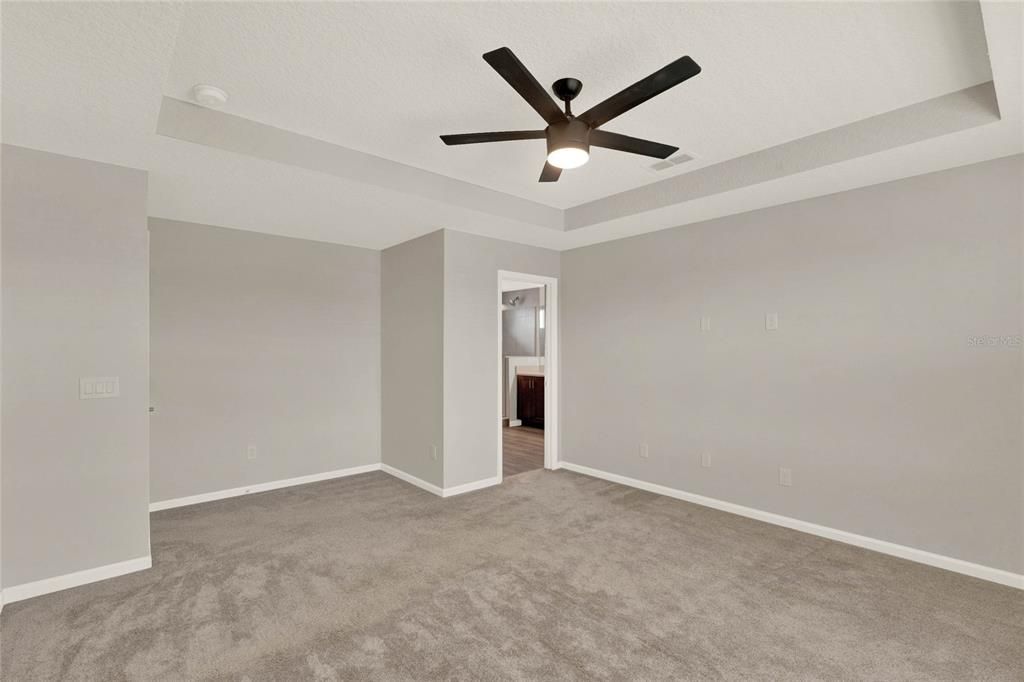 Primary bedroom with updated ceiling fan & light fixture