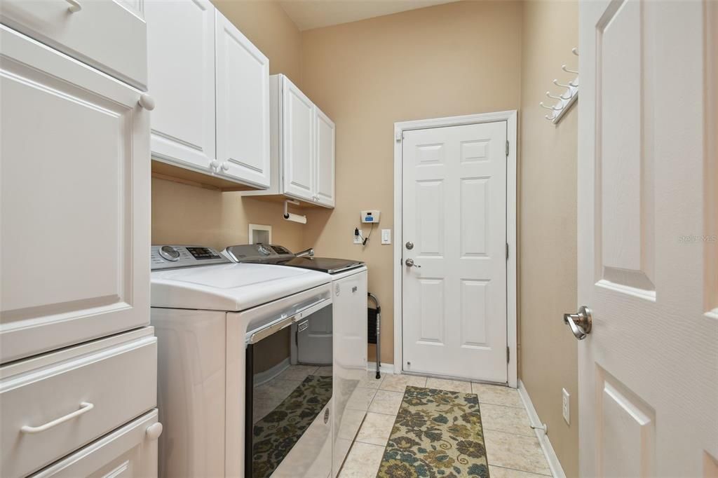 The laundry room features a spacious utility sink, washer & dryer with plenty of storage, making everyday tasks both efficient and enjoyable~