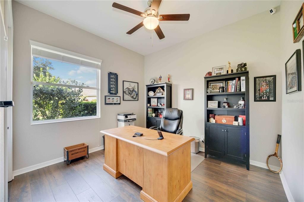 Third Bedroom with laminate flooring, ceiling fan, closet with built ins