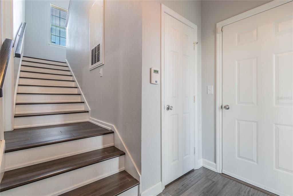 Ground floor landing. Door on the far right leads into 1-car garage. Stairs lead to the 2nd level.