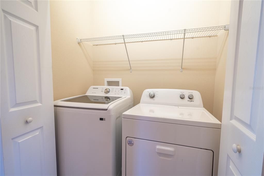 In the upstairs hallway you'll find a convenient washer and dryer with shelving above.