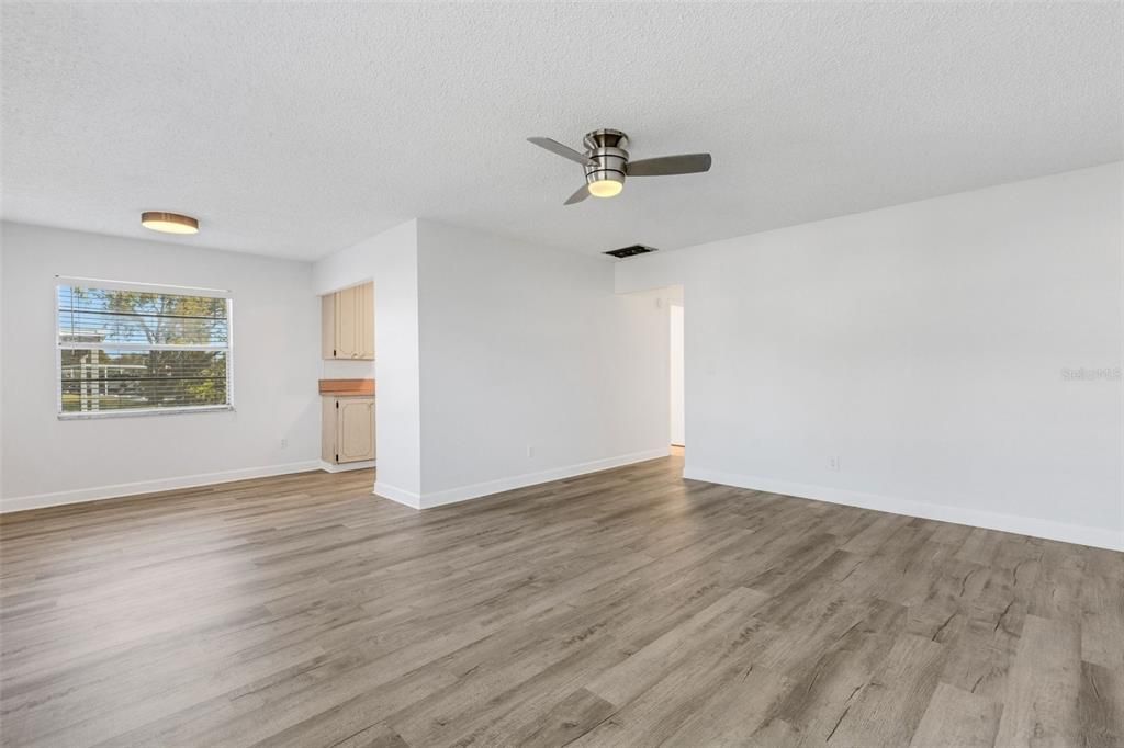 Spacious living room with dinette access. New paint, new ceiling fan.