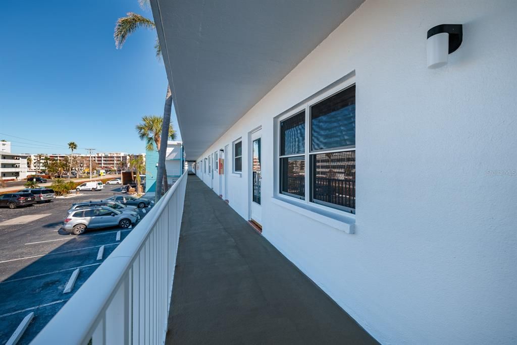 Walkway to elevator. Laundry room across from elevator & each floor has a laundry room.