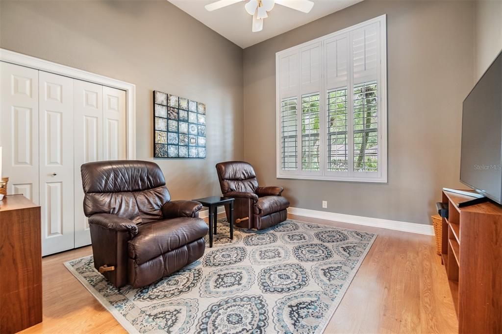 Office/Den/Sitting Room, Plantation Shutters with Pergo Flooring and ceiling fan.