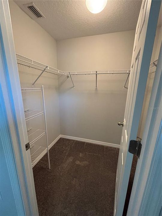 partial view of main bedroom walk-in closet